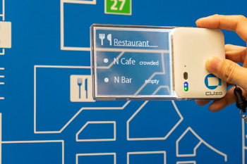 Photo8:Displaying seating availability of a café and bar by holding the display over a restaurant icon on an information sign